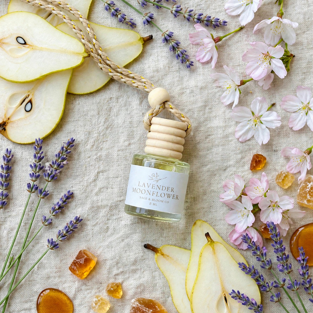 Lavender Moonflower car diffuser flat lay with pear and lavender props