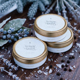 Stacked Nordic Nights travel tin candles with frost and bayberries