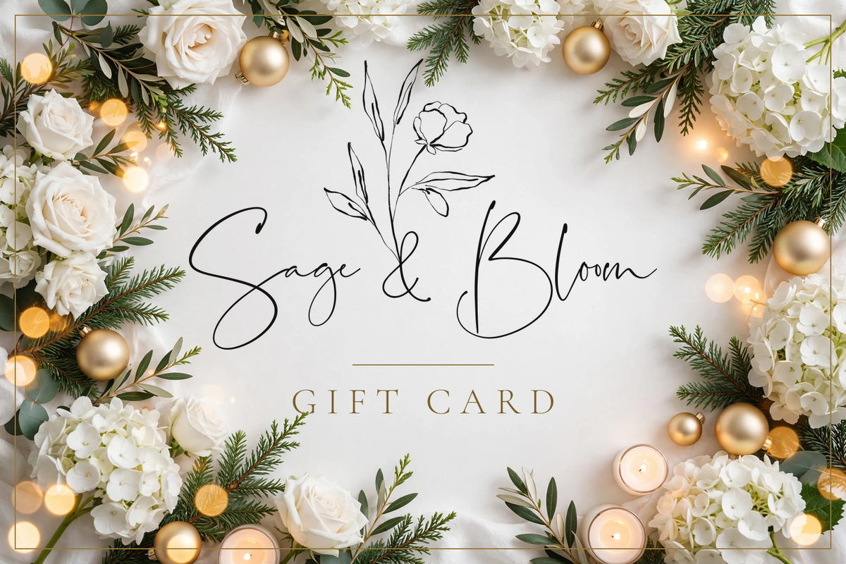 Sage and Bloom Co gift card in a holiday design with white roses, hydrangeas, evergreen, gold ornaments and candlelight