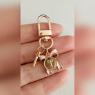 Bow Initial Bag Charm - Letter Charm T close-up held in hand