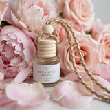 Blushing Peony car diffuser among peonies