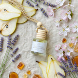 Lavender Moonflower car diffuser flat lay with pear and lavender props