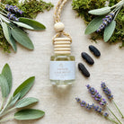Amber Oakmoss car diffuser flat lay with sage, lavender, oakmoss and tonka beans