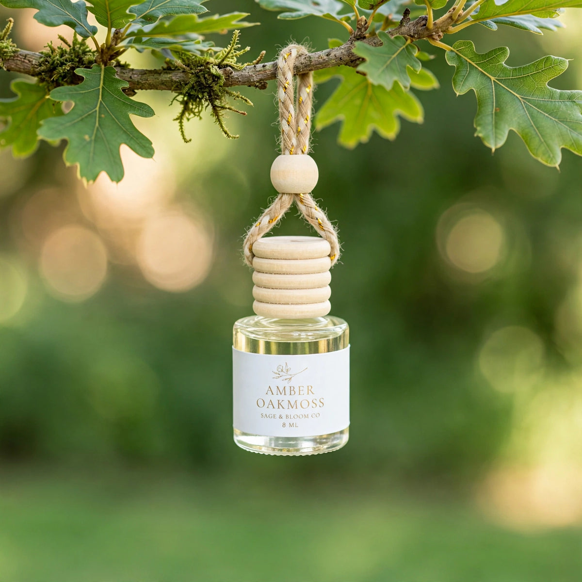 Amber Oakmoss car diffuser hanging from a mossy oak branch