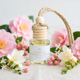 Camellia Patchouli Flower car diffuser styled with pink camellias, berries, freesia and jasmine