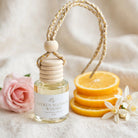 Citrus Blossom Woods car diffuser styled with citrus slices, orange blossoms and rose