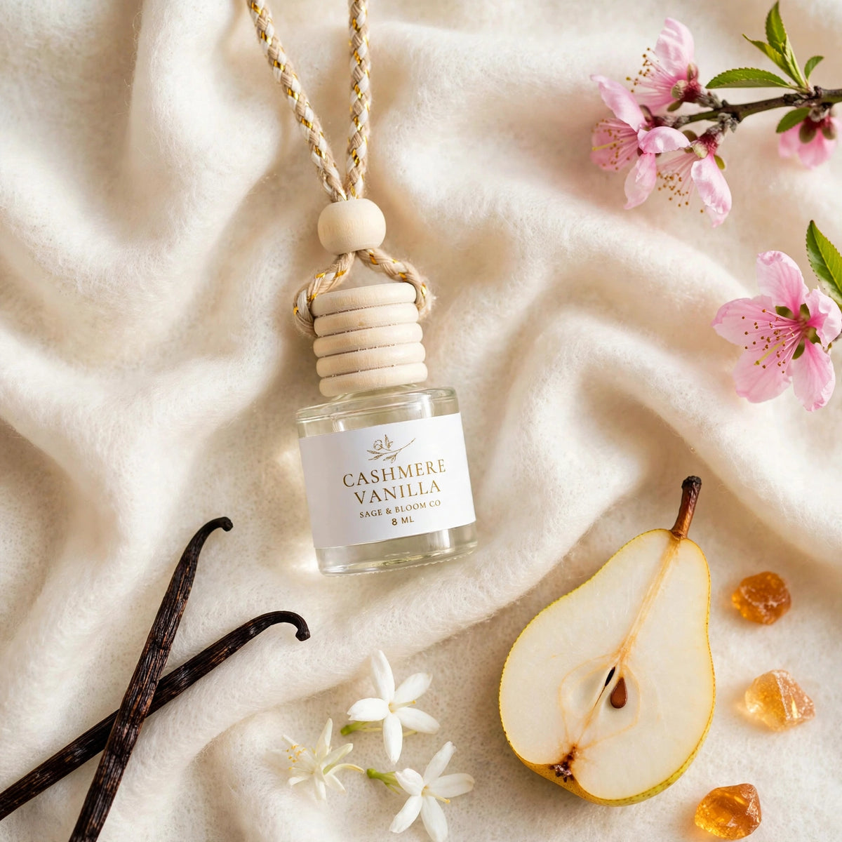 Cashmere Vanilla car diffuser flat lay on rich cashmere with vanilla beans, pear, jasmine and amber