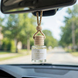 Cashmere Vanilla car diffuser hanging behind the rearview mirror on a summer drive