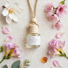 Magnolia Peony car diffuser flat lay with magnolia, peony petals, freesia, cherry blossom and amber