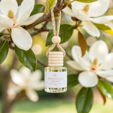Magnolia Peony car diffuser hanging from a magnolia branch