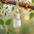 Oud Patchouli Resins car diffuser hanging from a resin-covered branch