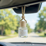 Pink Peony Grapefruit car diffuser hanging behind the rearview mirror on a summer drive