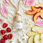 Prosecco Raspberries car diffuser flat lay with raspberries, apple, peach, lily petals and jasmine