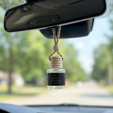Rouge Saffron car diffuser hanging behind the rearview mirror on a summer drive