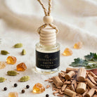 Sandalwood Smoke car diffuser styled with sandalwood logs, cardamom, pepper, leather and amber