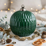 Closed green glass Christmas ornament candle with muted gold ribbon