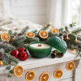 Christmas ornament candle on holiday mantel with garland