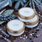 Stacked Nordic Nights travel tin candles with frost and bayberries