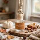 Vanilla Pumpkin Santal car diffuser on a fall tabletop with a white pumpkin and cinnamon